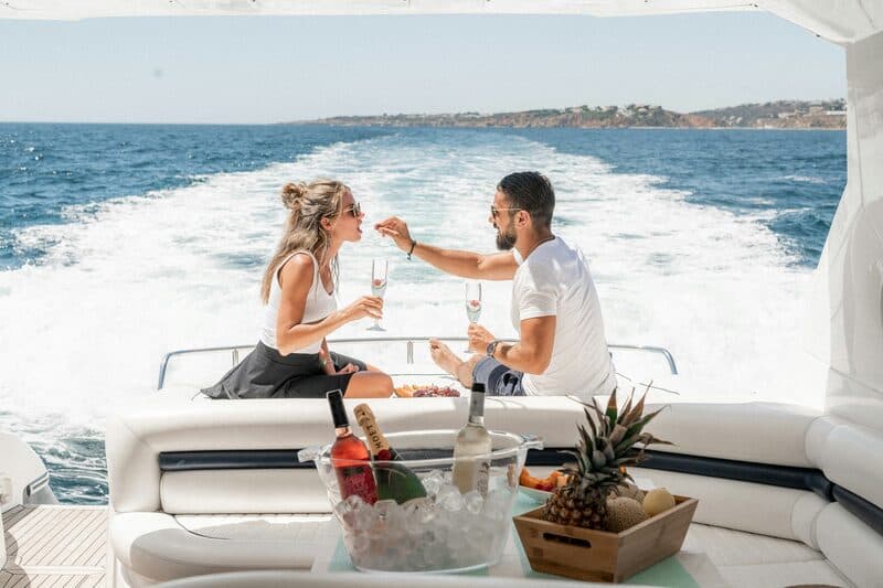 Couple celebrating on a luxury yacht with champagne